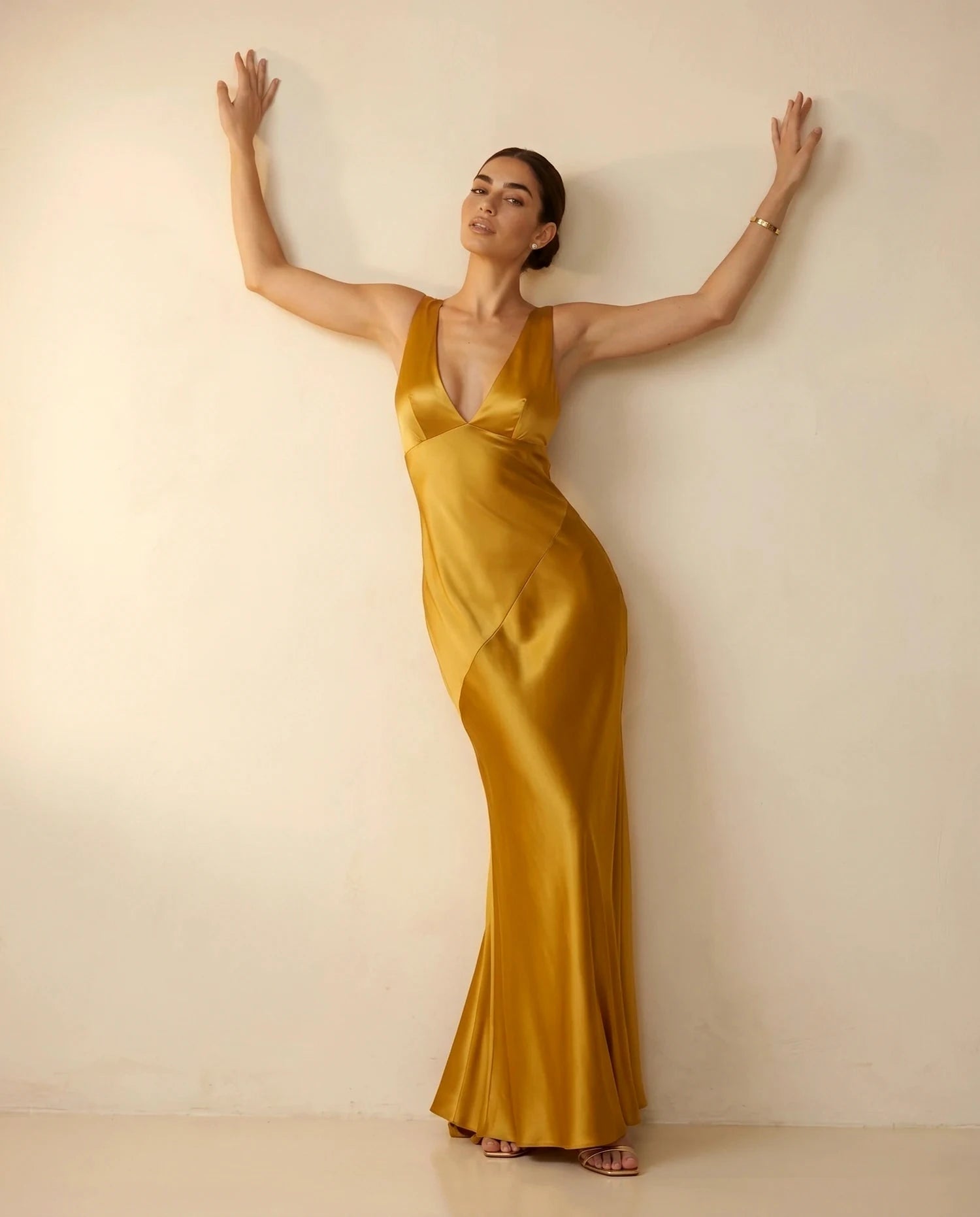 Aurelia Maxi Dress – Black Satin V Neck maxi dress, editorial wall pose by Slimona