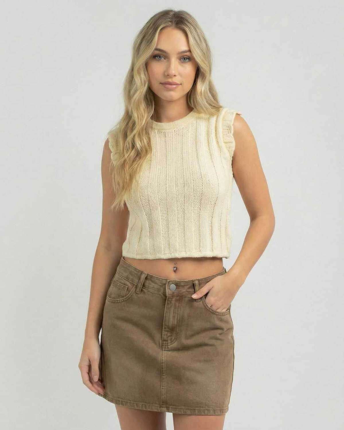 Woman wearing Lauven Monaco Top, a sleeveless knit top, with a casual summer skirt.