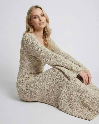 Model wearing Sienna Maxi Dress by Lauven, a beige maxi sweater dress with long flare sleeves.