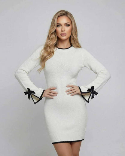 Lauven Monaco Mini Dress in white with long sleeves and bow detail, featuring black trim accents.