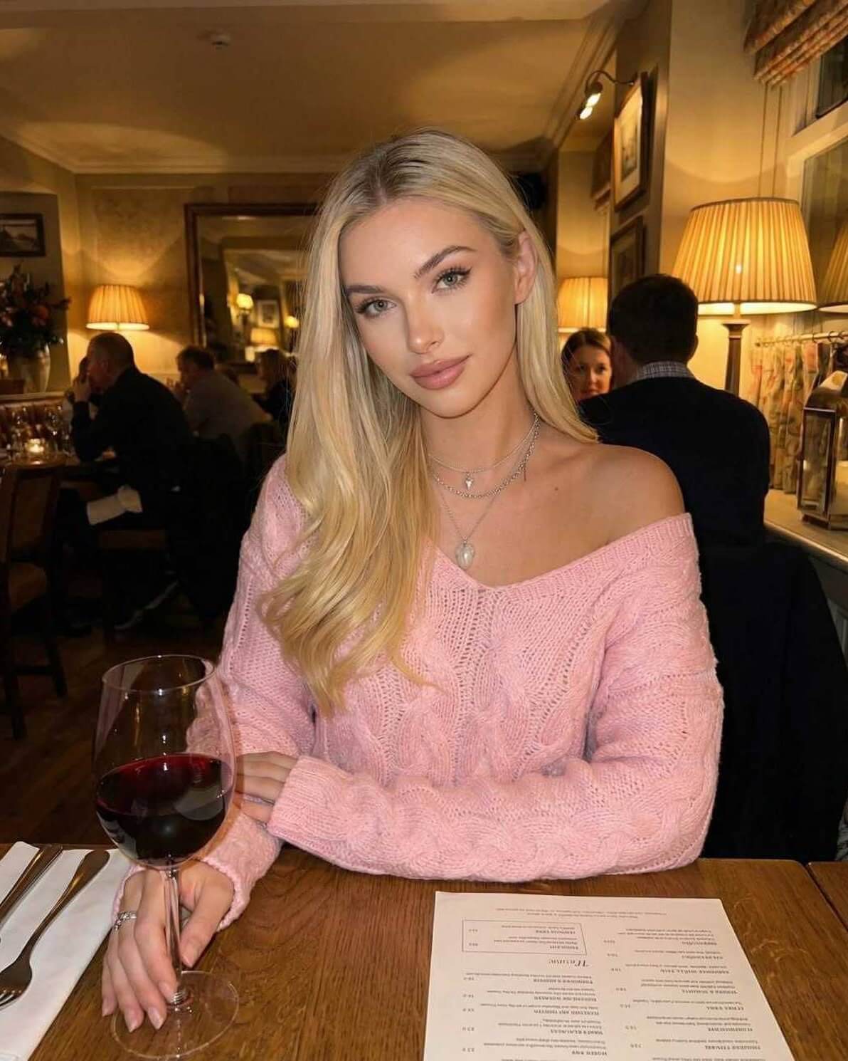 Sienna Sweater by Lauven - Women’s pink V-Neck rib knit sweater worn elegantly at a restaurant.
