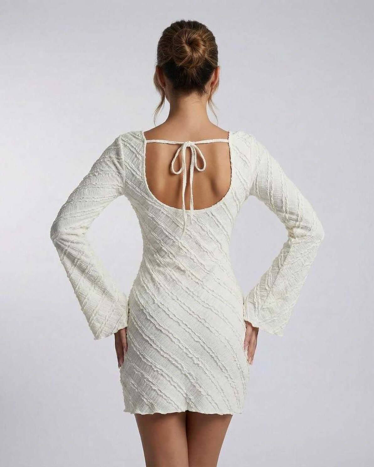 Sienna Mini Dress by Lauven showcasing the back view with a textured finish and long sleeves.
