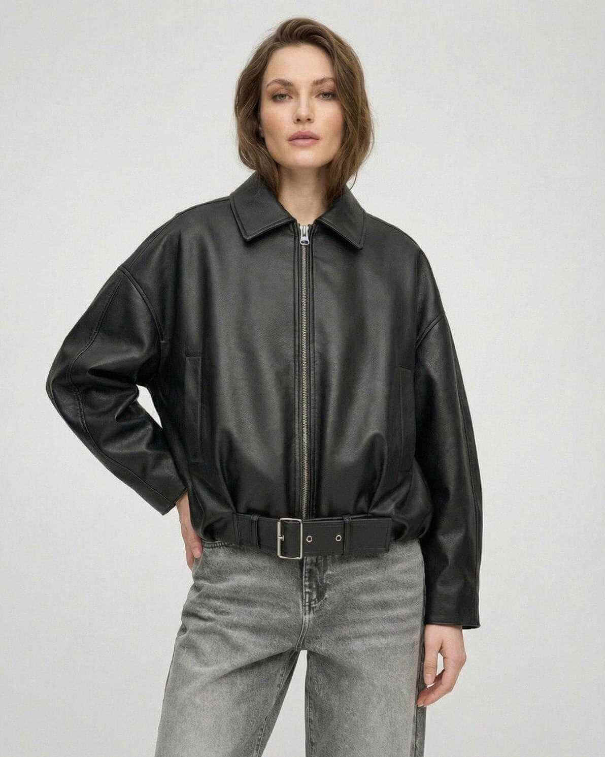 Women wearing a Black Belted Jacket by Lauven, featuring an oversized zip style and leather-look finish.