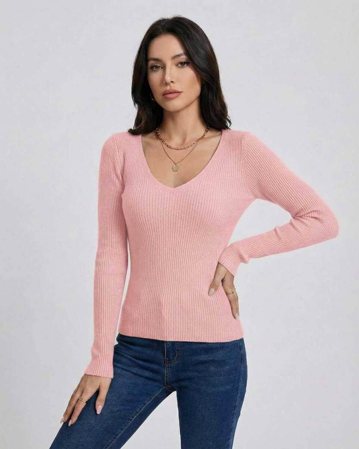 Elegant woman wearing a pink Florence Pullover by Lauven, showcasing a V-neck and slim fit design.