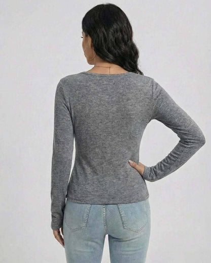 Back view of a woman wearing the Lauven Sterling Pullover in gray, showcasing its slim fit and long sleeves.
