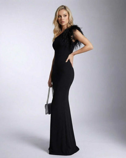Noirelle Maxi Dress by SLIMONA featuring a one shoulder feather detail and mermaid silhouette in elegant black.