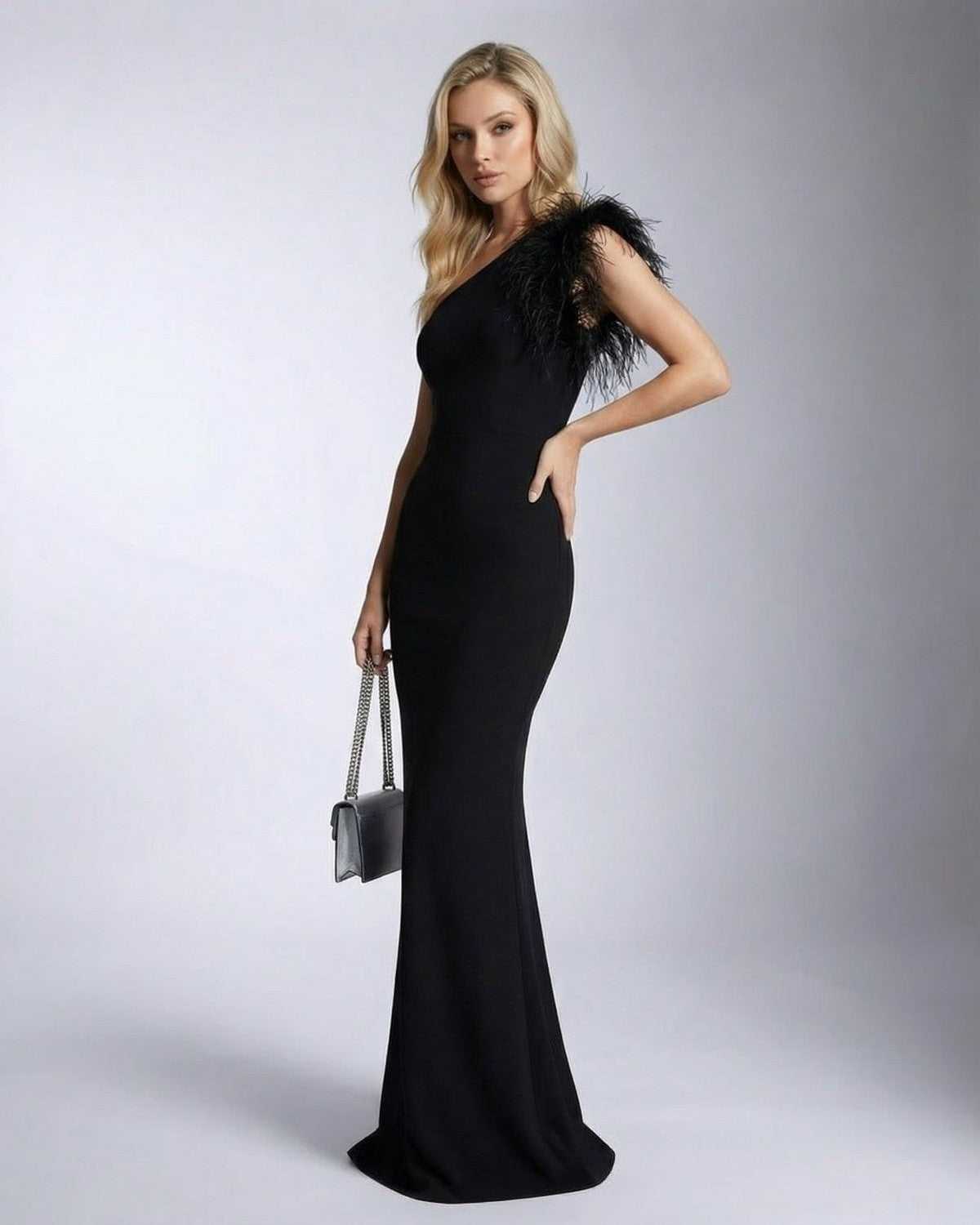 Noirelle Maxi Dress by SLIMONA featuring a one shoulder feather detail and mermaid silhouette.