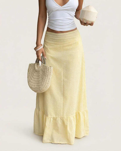 Model wearing the Solara Maxi Skirt by SLIMONA, showcasing a flared silhouette with soft striped texture.