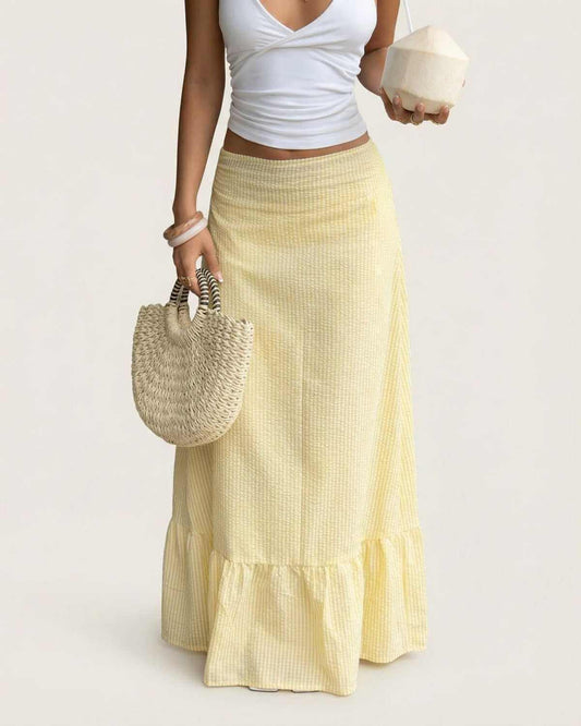 Model wearing the Solara Maxi Skirt by SLIMONA, showcasing a flared silhouette with soft striped texture.