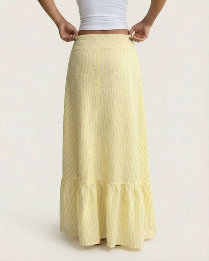 Solara Maxi Skirt by SLIMONA, showcasing flared silhouette and soft striped texture in yellow.