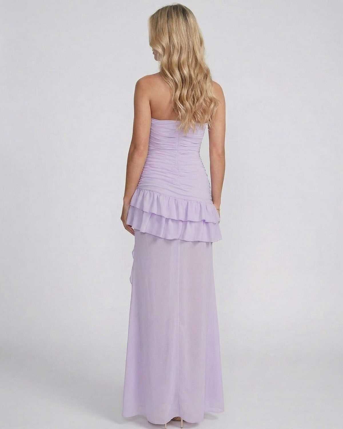 Lavelle Maxi Dress by SLIMONA showcasing cowl neck and layered ruffle design in soft lavender from the back.