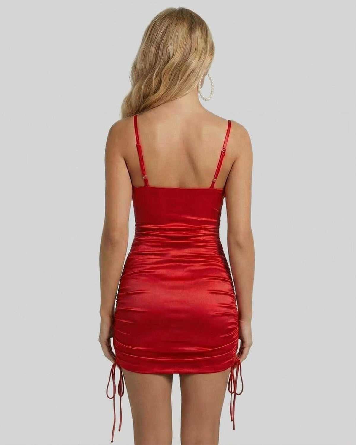 Back view of the Valencia Mini Dress by SLIMONA, showcasing its ruched detail and satin finish.