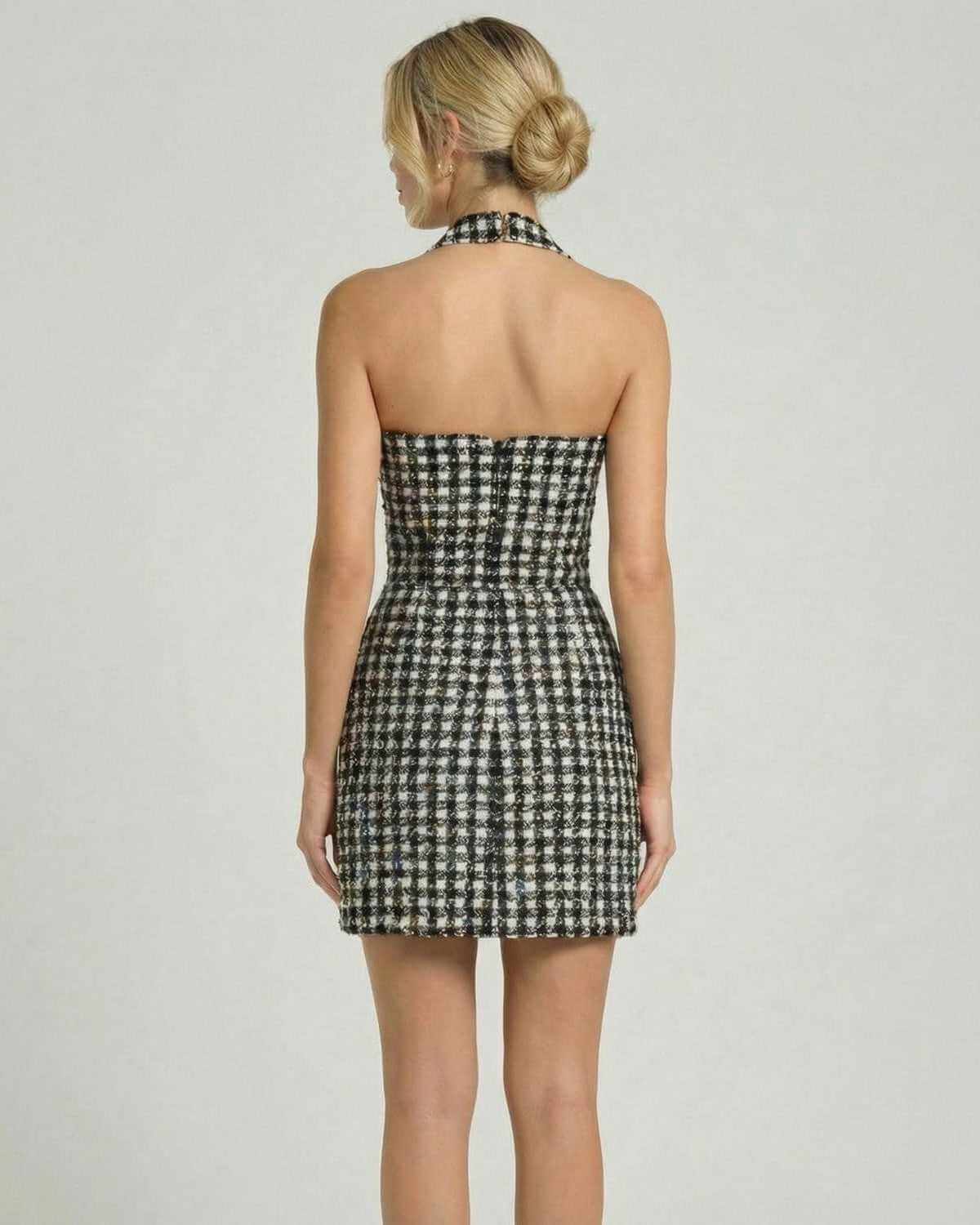 Back view of the Aurelia Mini Dress by SLIMONA, featuring a halter neck and plaid pattern, perfect for elegant occasions.