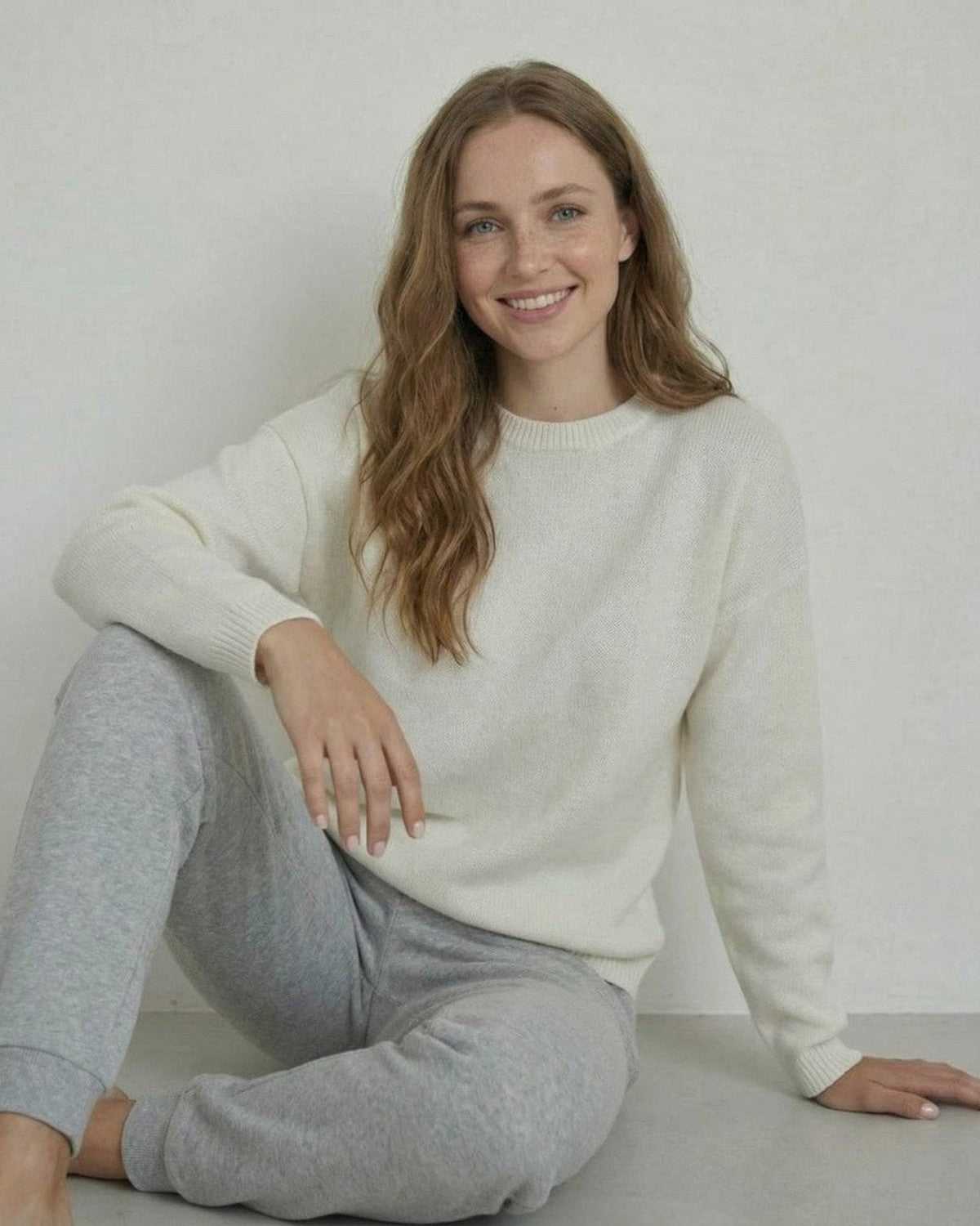 Woman wearing Alba Pullover by SLIMONA, showcasing relaxed wool knit and modern style, perfect for cozy days.