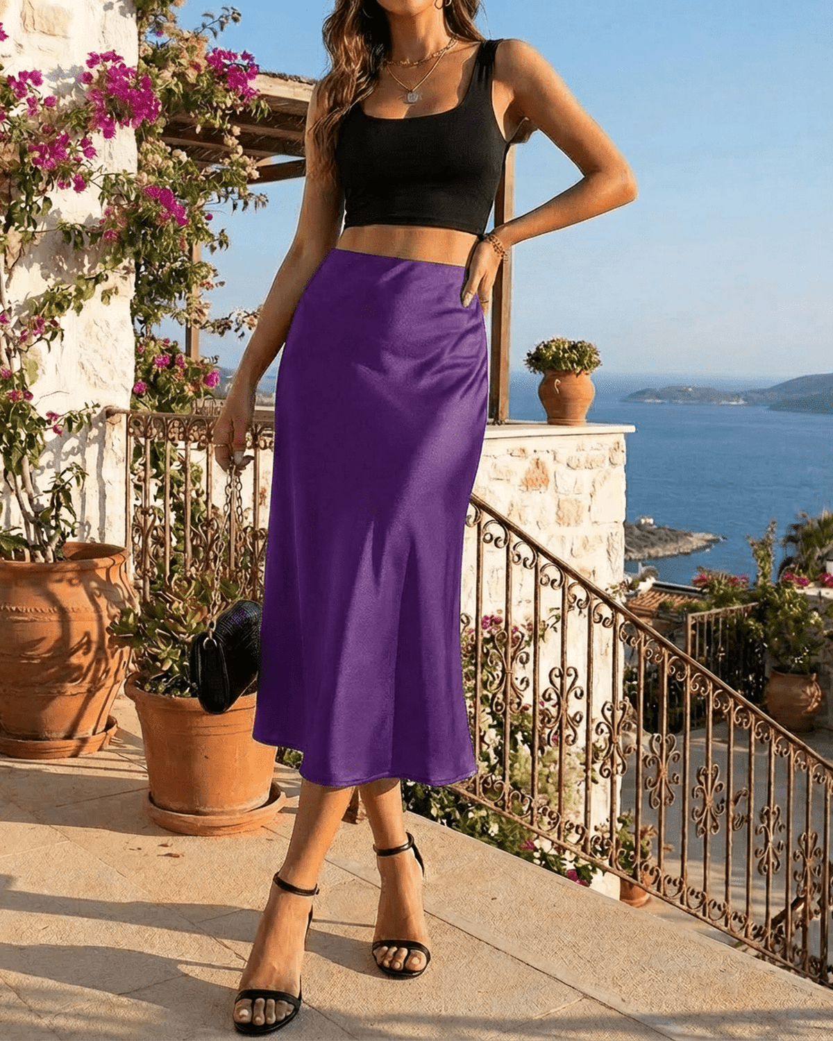 Amethyst Midi Skirt by SLIMONA, a vibrant purple satin mermaid midi skirt styled with a black crop top.