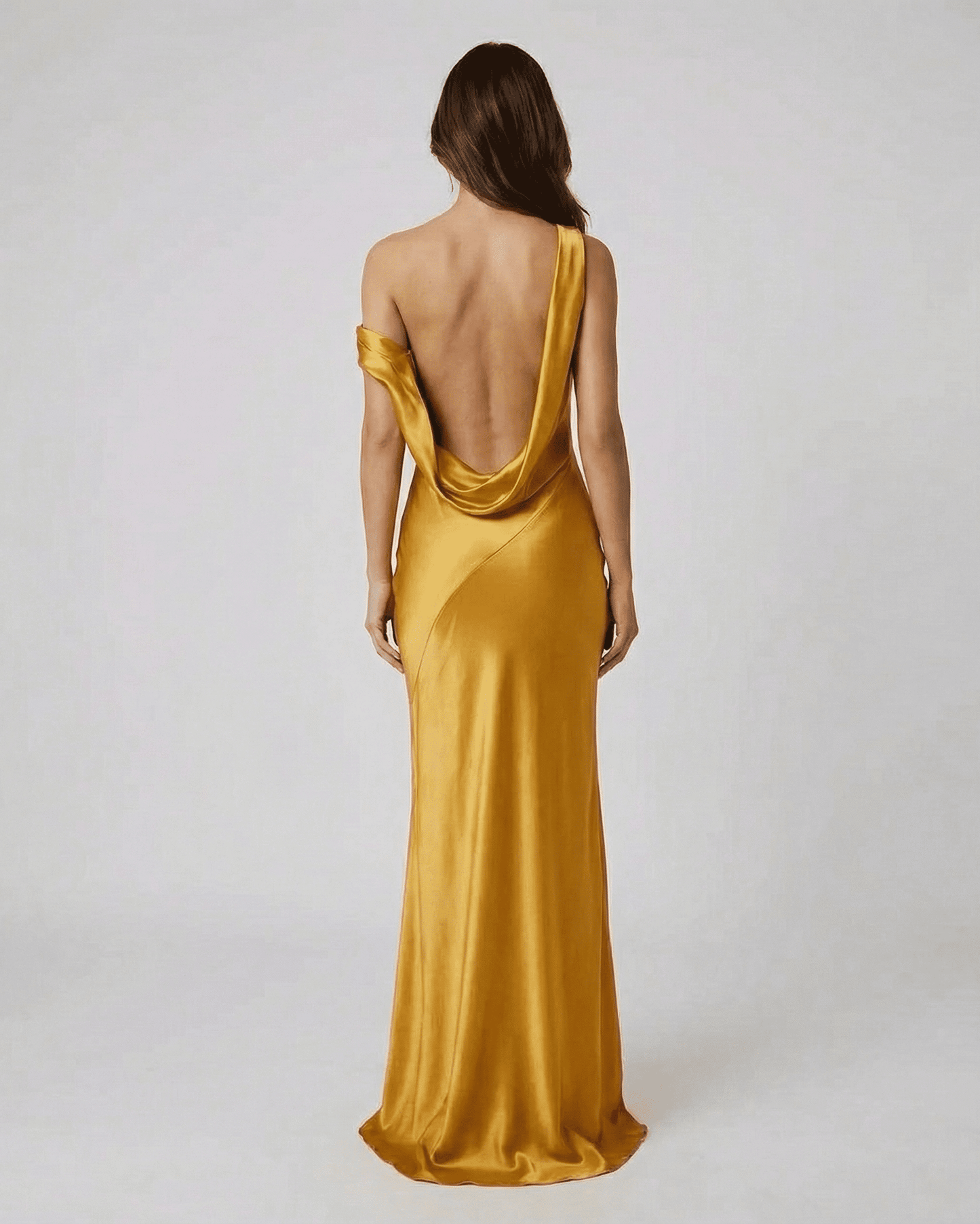 Aurelia Maxi Dress by SLIMONA in satin gold showcasing an open back and high waist design, perfect for elegant occasions.