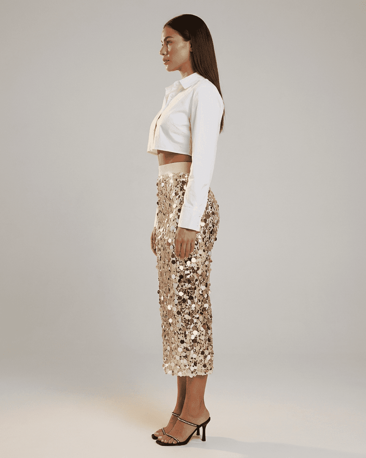 Aureline Midi Skirt by SLIMONA, featuring a high waist and sequin detail, styled for an elegant evening look.