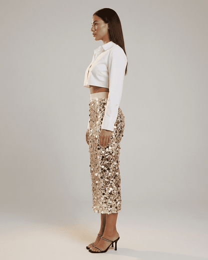 Aureline Midi Skirt by SLIMONA, featuring a high waist and sequin detail, styled for an elegant evening look.