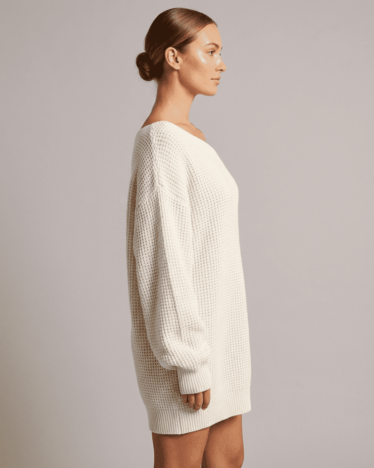 Aurora Mini Dress by SLIMONA showcasing a side view of the white ribbed knit off-the-shoulder lantern sleeve.