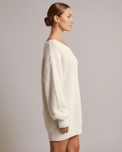 Aurora Mini Dress by SLIMONA showcasing a side view of the white ribbed knit off-the-shoulder lantern sleeve.