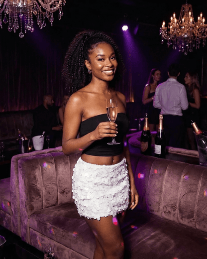 Bianca Mini Skirt worn by a woman in a chic setting, showcasing the SLIMONA brand's elegant style.