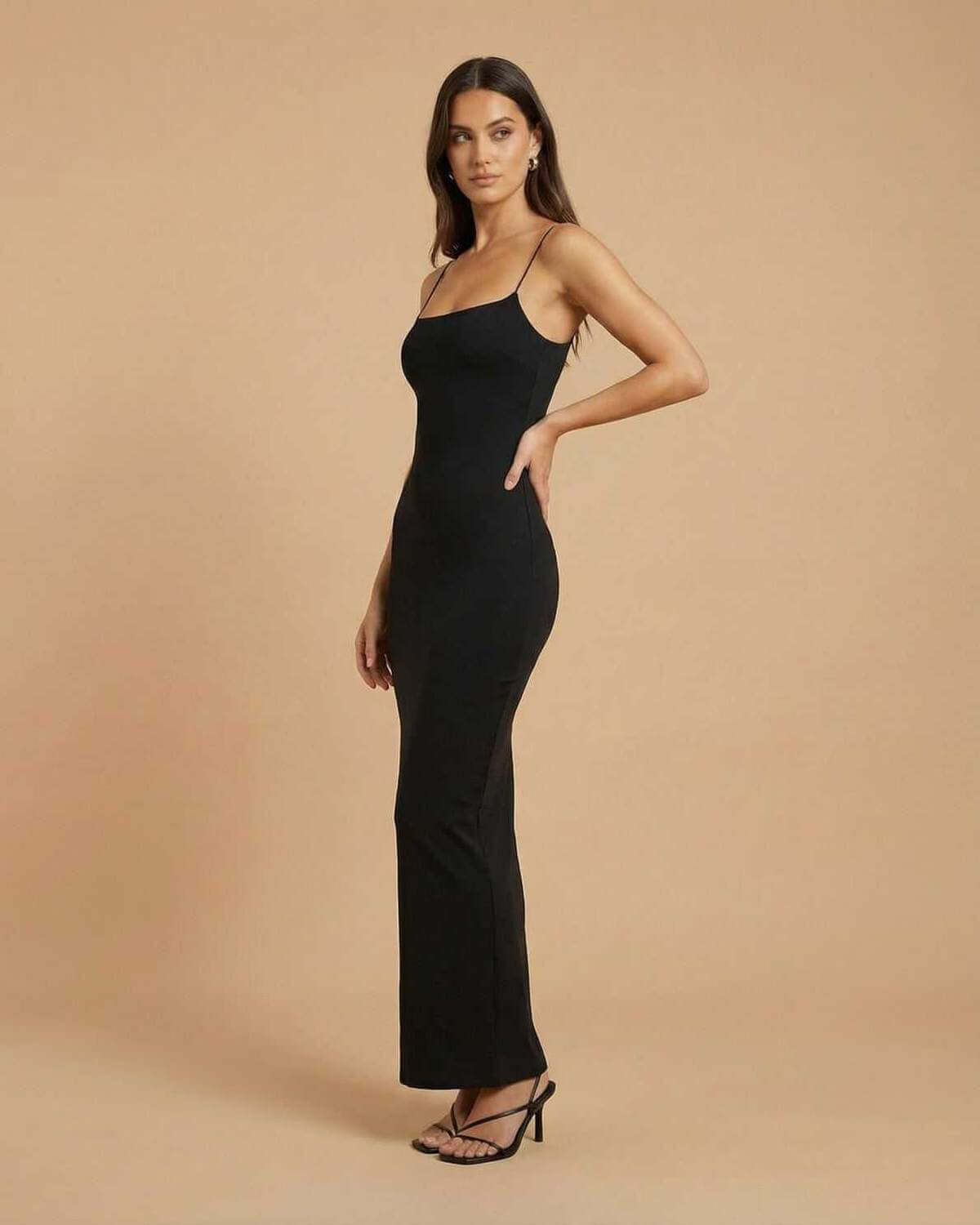 Calypso Maxi Dress by SLIMONA, a sleek black backless maxi dress in a streamlined silhouette.