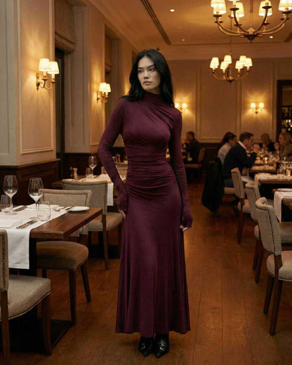 Celeste Maxi Dress by Lauven displayed in a chic restaurant setting, showcasing its elegant burgundy sheath silhouette.