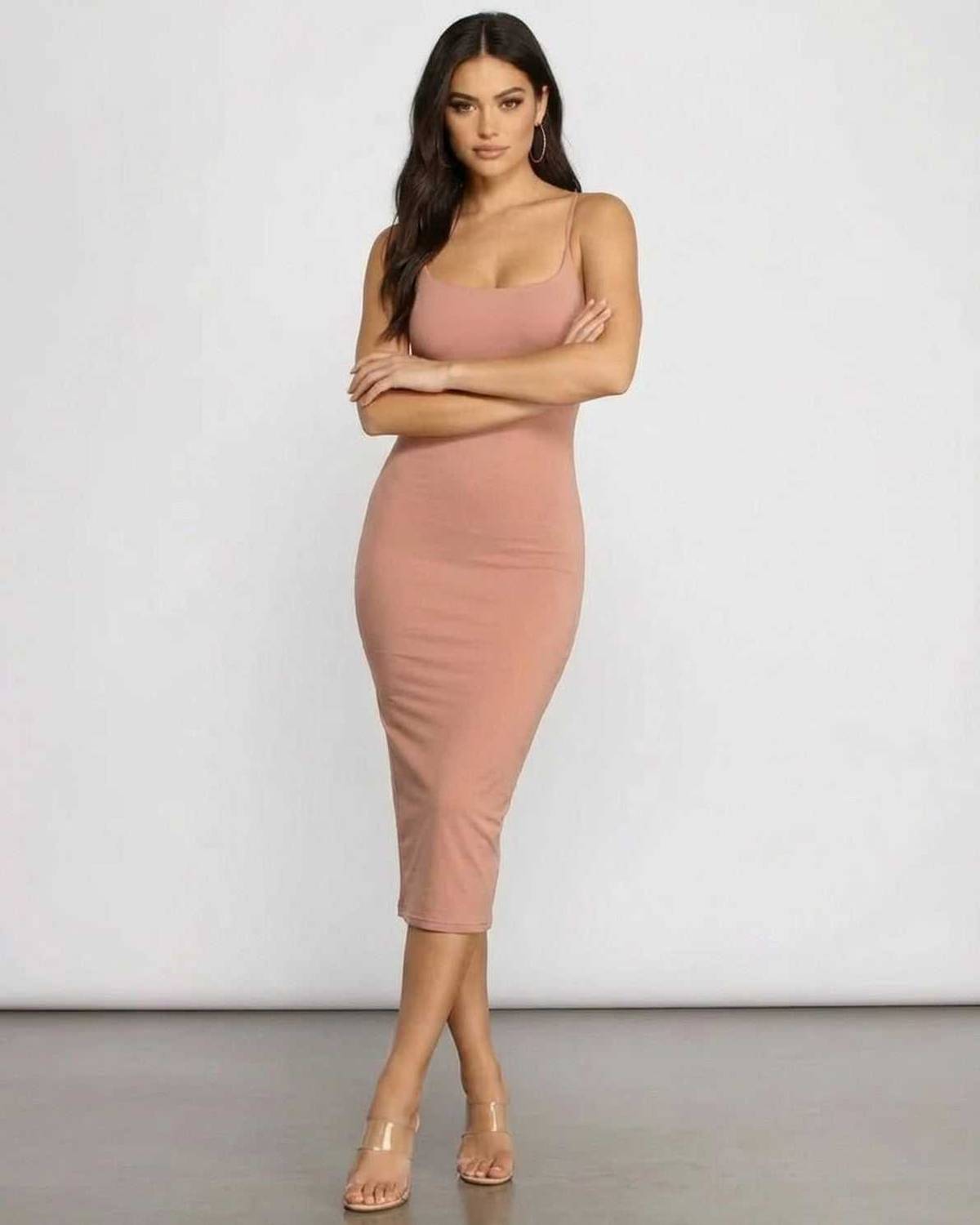 Model wearing the Celeste Midi Dress by SLIMONA, showcasing its elegant curve-hugging silhouette.