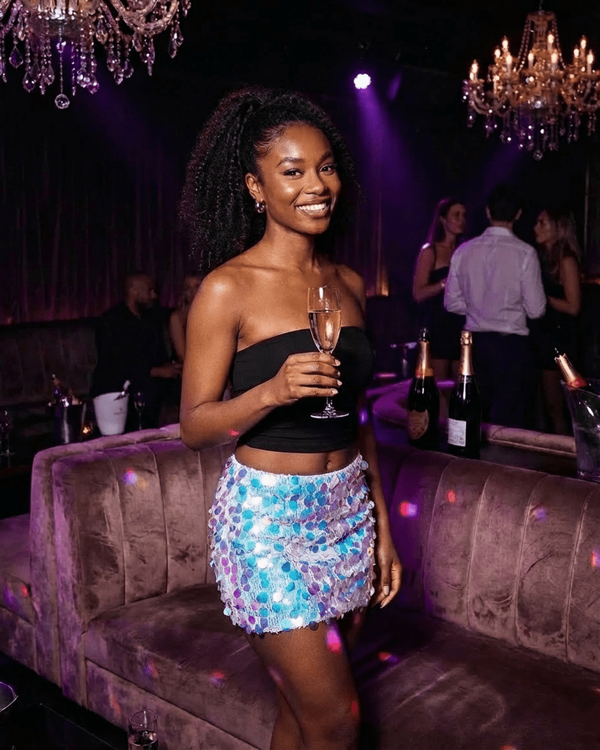 Celeste Mini Skirt by SLIMONA showcased at a party, featuring blue iridescent sequins and a stylish A-line silhouette.