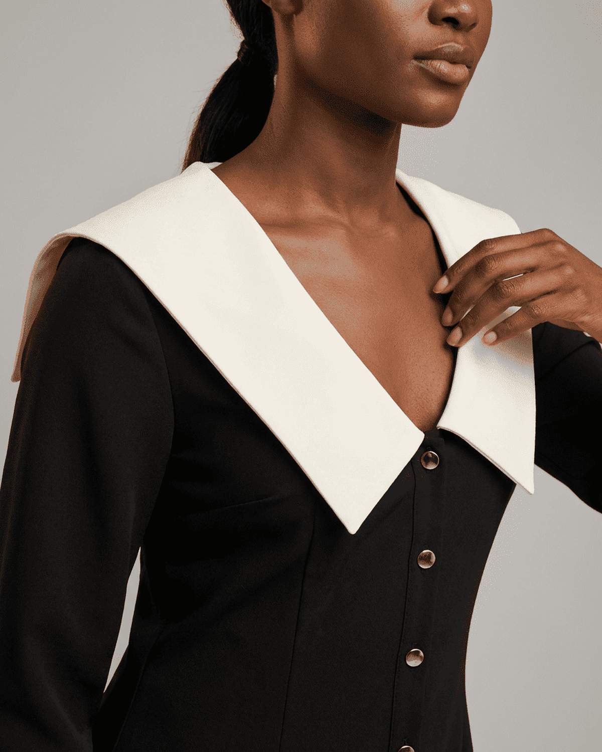 Corinne Mini Dress by SLIMONA featuring a stylish wide collar and elegant bodycon fit in black and white color block design.