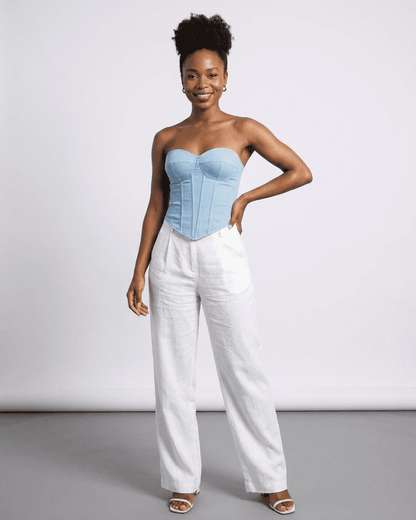 Model wearing Denali Corset Top by SLIMONA, a stylish faux denim cup bustier with a structured slim design.