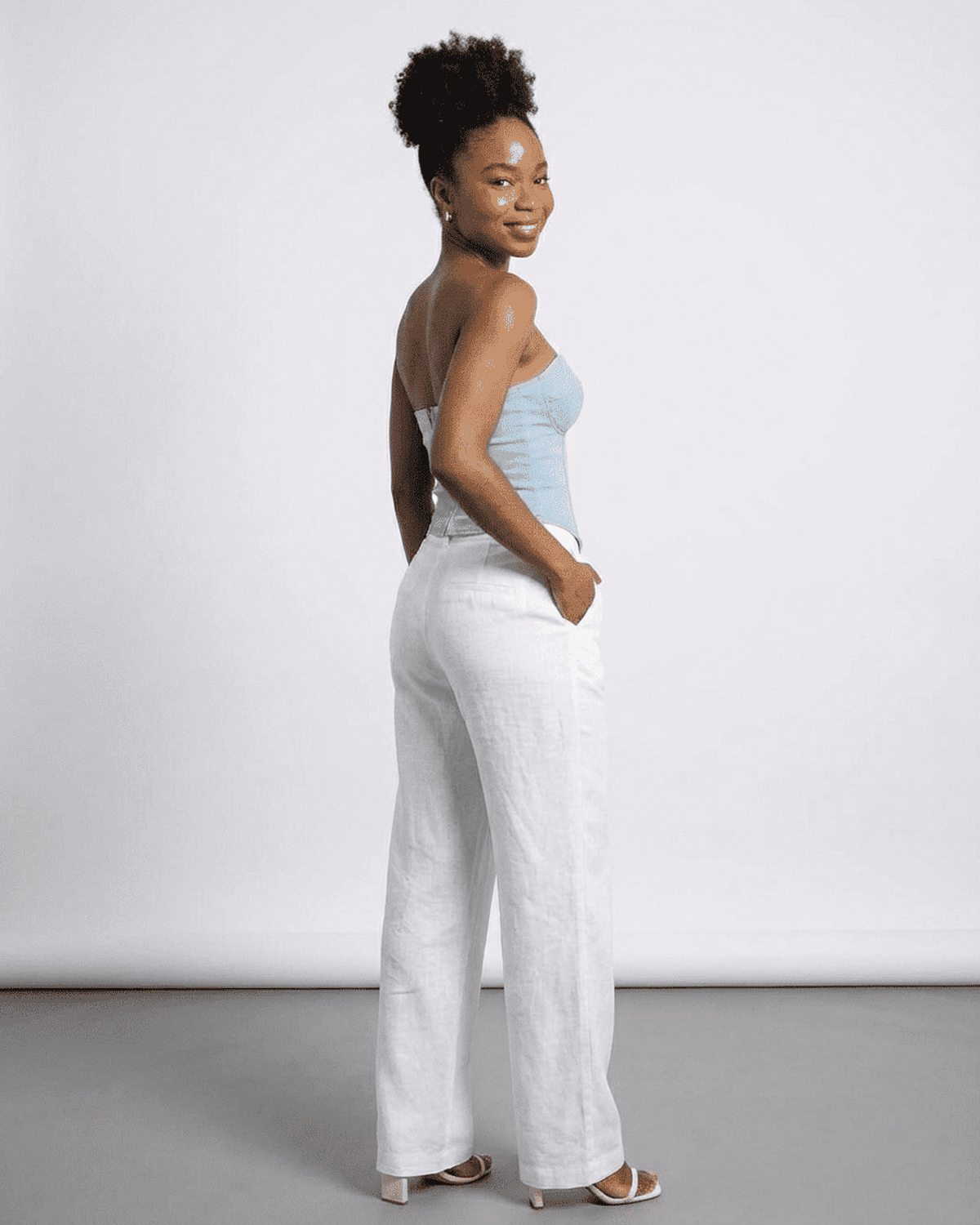 Denali Corset Top by SLIMONA showcased on a model wearing white pants, highlighting its stylish slim design.