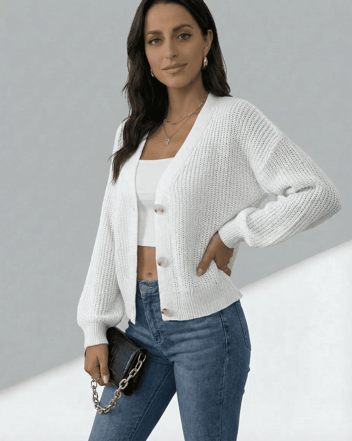 Model wearing Elara Cardigan by SLIMONA, showcasing a lightweight button-front knitwear styled with jeans.