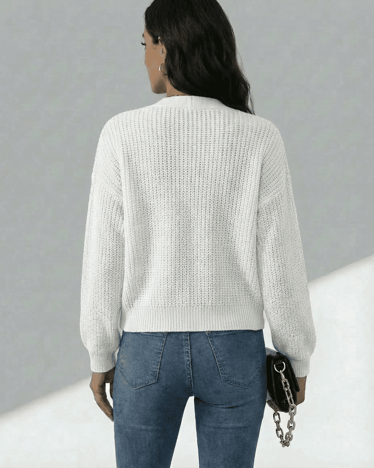 Back view of a woman wearing the Elara Cardigan by SLIMONA, showcasing its lightweight knit texture.