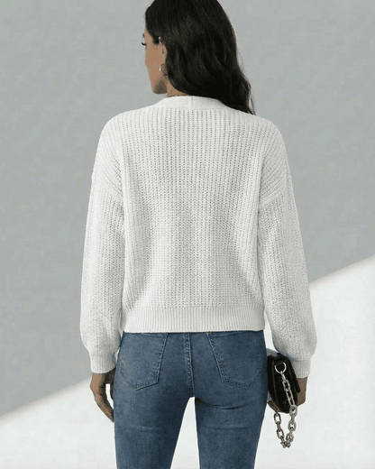 Back view of a woman wearing the Elara Cardigan by SLIMONA, showcasing its lightweight knit texture.