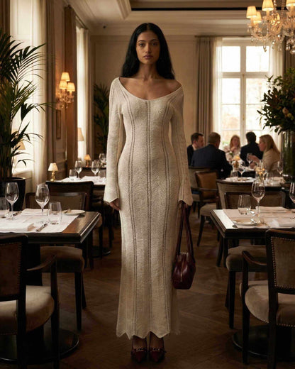 Elara Maxi Dress by Lauven featuring a ribbed V-neck and long flare sleeves, showcased in an elegant dining setting.