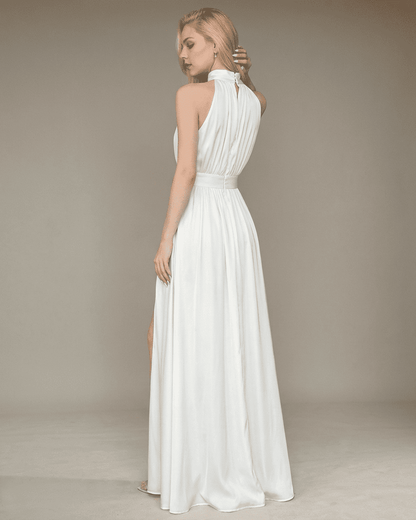Elegant back view of the Elara Maxi Dress by SLIMONA, showcasing sleeveless turtleneck design and side slit.