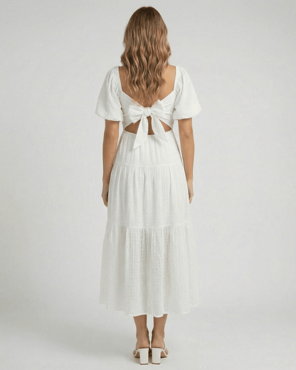 Back view of the Elara Midi Dress by Lauven with puff sleeves and a bow detail in elegant white.