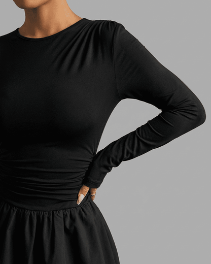 Elara Mini Dress by SLIMONA, elegant long sleeve tiered design in black, showcasing a flattering fit.