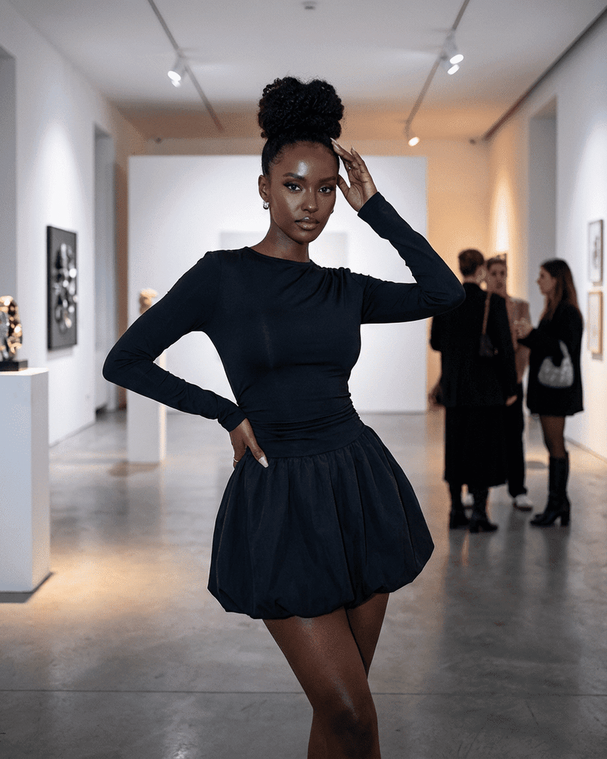 Elara Mini Dress by SLIMONA worn by model in an art gallery showcasing elegant long sleeve tiered design.