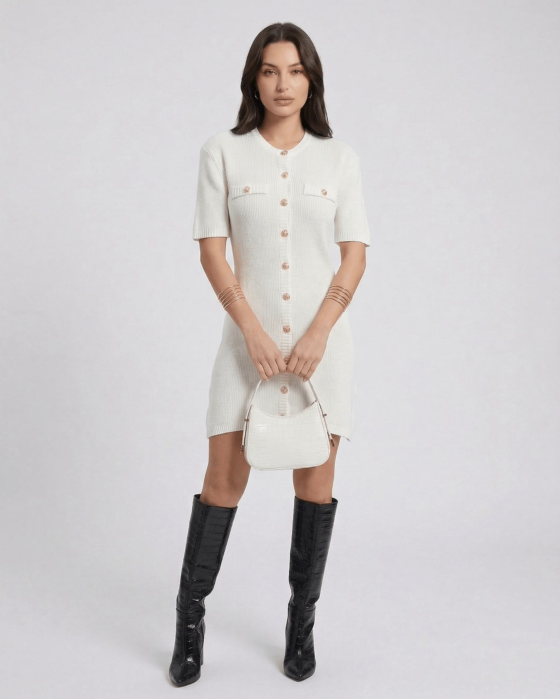 Elysia Mini Dress by Lauven featuring a chic knit design and button closure, styled with knee-high boots and a handbag.