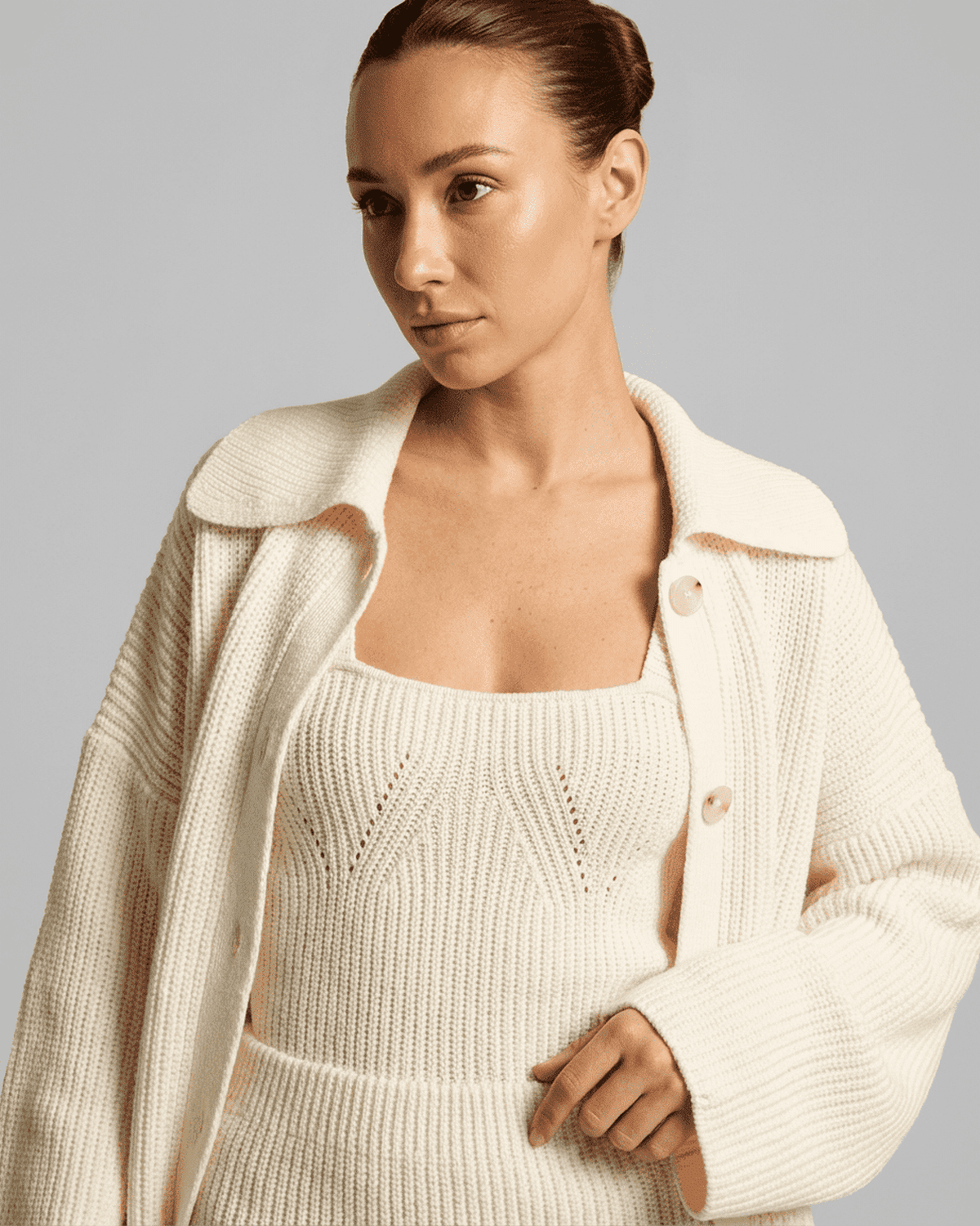 Elysia Mini Dress by SLIMONA worn with a cozy knit cardigan, showcasing a fitted bodycon silhouette and elegant style.