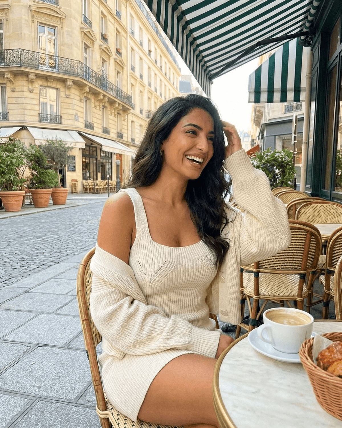 Elysia Mini Dress worn by a smiling woman at a cafe, showcasing chic fitted knit bodycon style by SLIMONA.