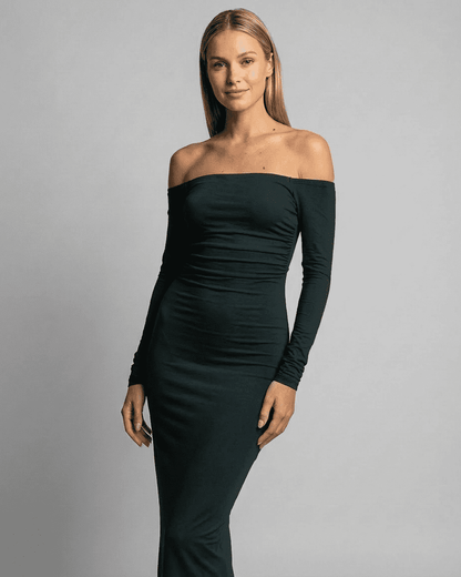 Emerald Maxi Dress by SLIMONA in a solid green off-shoulder style, showcasing a sleek silhouette and long sleeves.