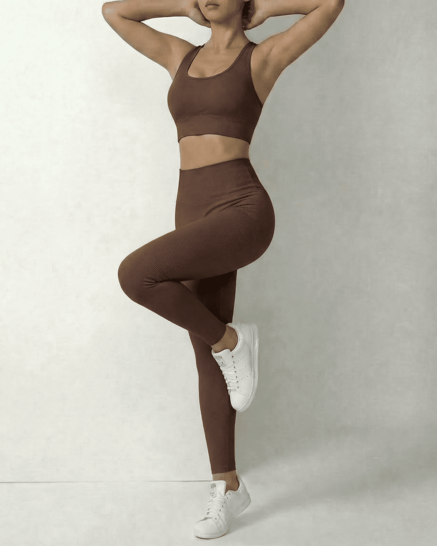 Model wearing Hazel Leggings and matching sports bra in sleek brown, showcasing comfort and style by SLIMONA.