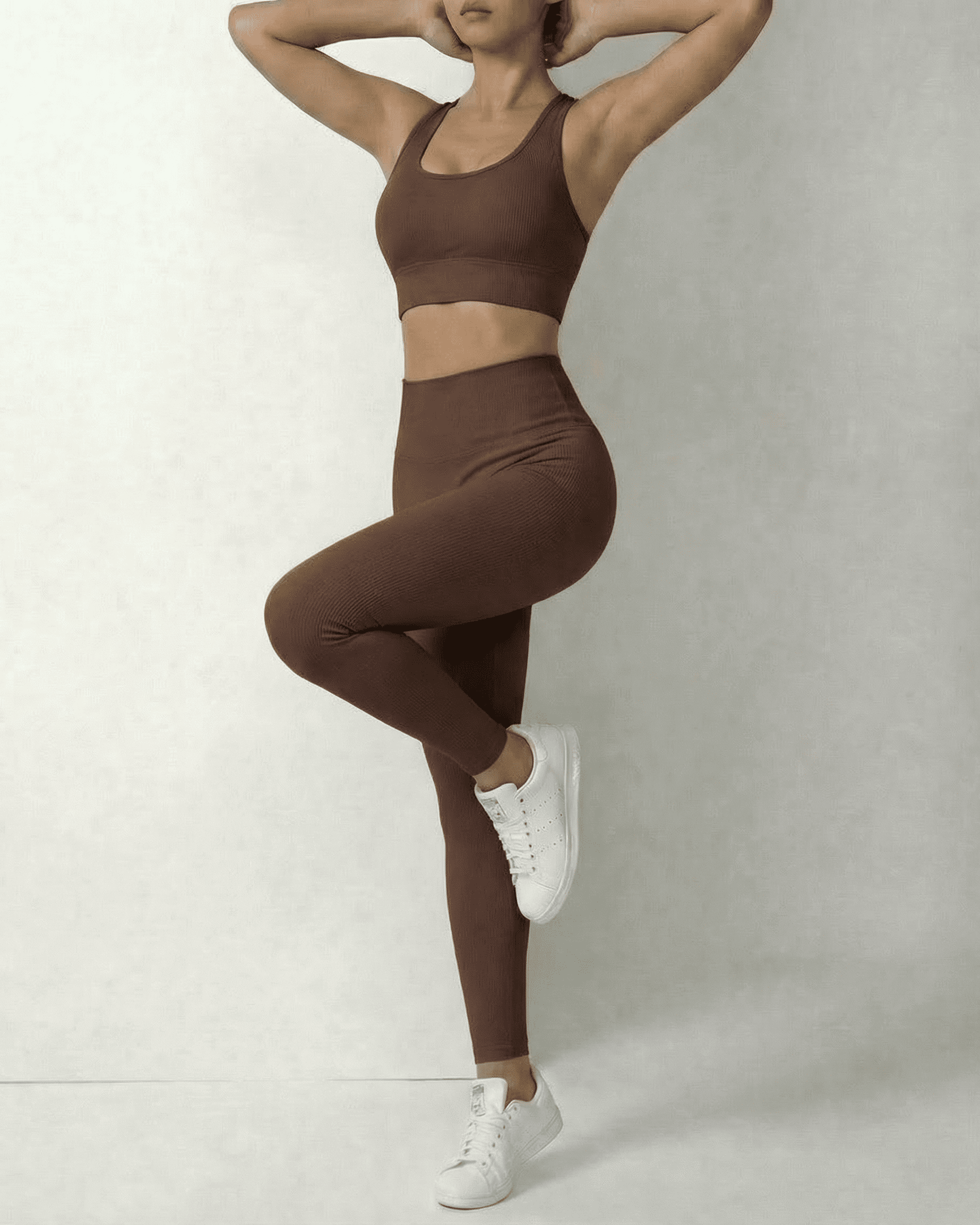 Model wearing Hazel Leggings and matching sports bra in sleek brown, showcasing comfort and style by SLIMONA.
