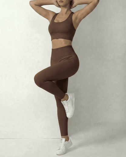 Model wearing Hazel Leggings and matching sports bra in sleek brown, showcasing comfort and style by SLIMONA.