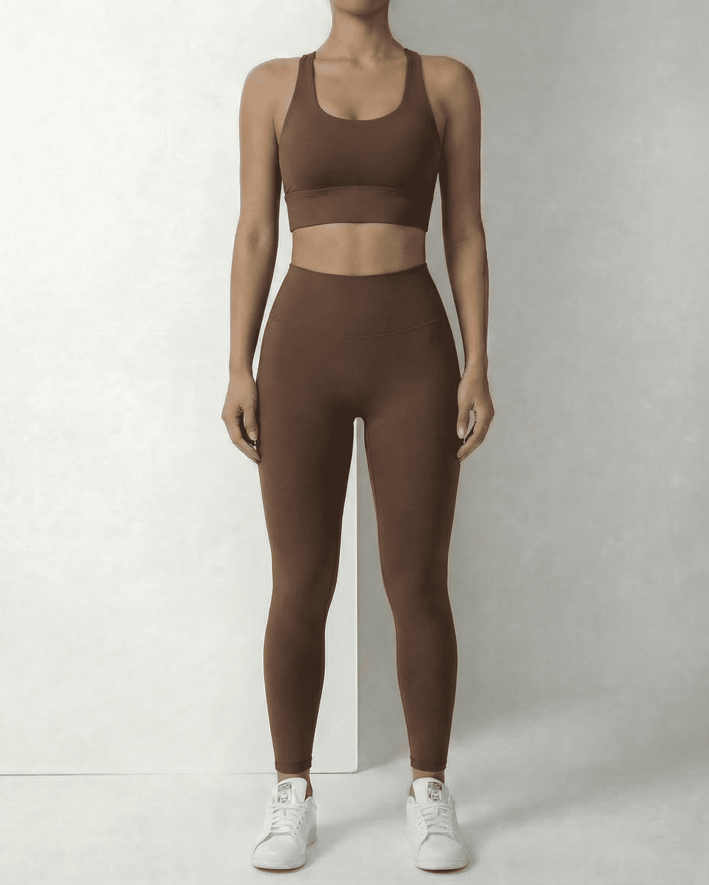 Model wearing SLIMONA Hazel Leggings and matching sports bra in sleek brown, showcasing comfort and style.