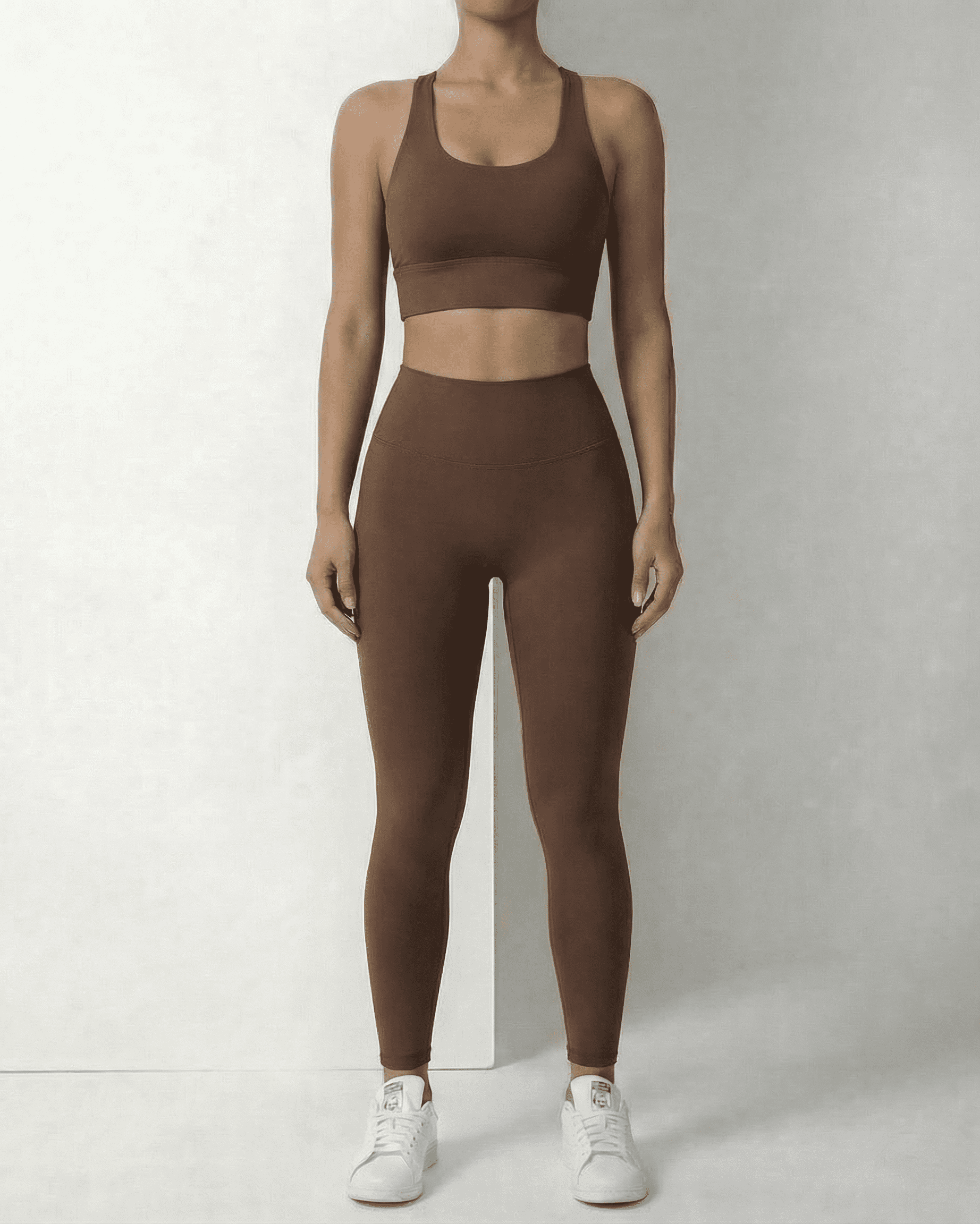 Model wearing SLIMONA Hazel Leggings and matching sports bra in sleek brown, showcasing comfort and style.