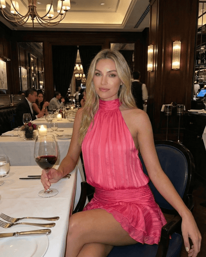 Roselle Mini Dress by SLIMONA, a stylish pink pleated chiffon mini dress, perfect for a chic dining experience.